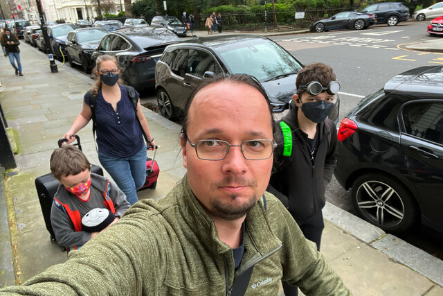 Jaeger walks on the pavement in Kensington with Julian, Kiesa, and Calvin