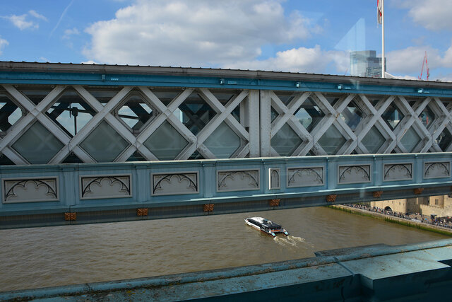 River bus on the Thames under the walkway of the Tower Bridge