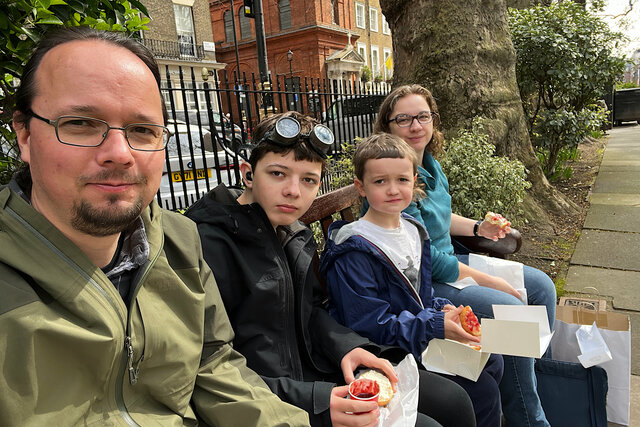 Jaeger, Calvin, Julian, and Kiesa eat scones in Soho Square Gardens