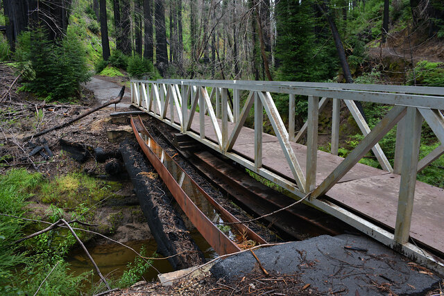 Burned beams under a temporary bridge over Opal Creek