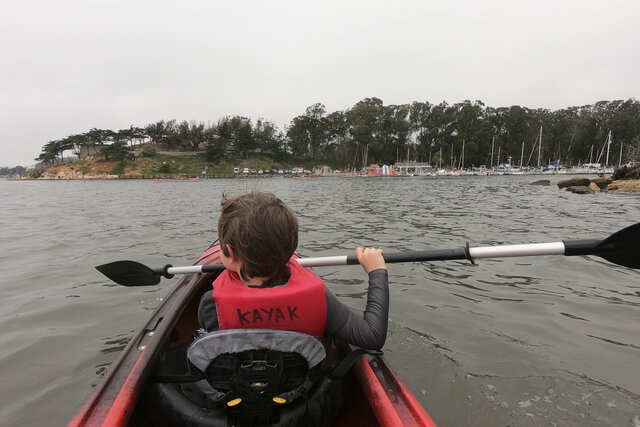 Julian kayaks towards the kayak dock