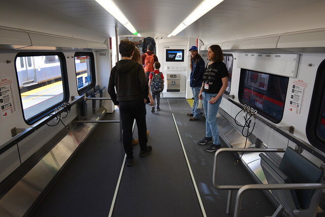 Calvin and Julian walk through the bike level of the Caltrain Stadler KISS EMU