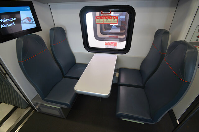 Four seats around a fixed table in the Caltrain Stadler KISS EMU