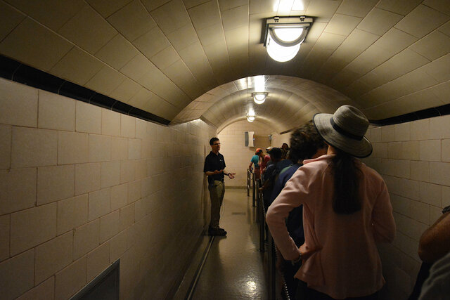 Tour guide addresses tour group inside Hoover Dam