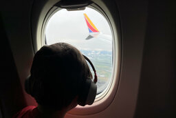 Julian looks out the window of a 737 MAX8