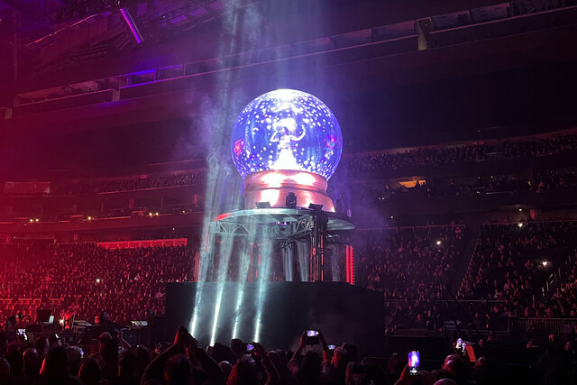 A Trans-Siberian Orchestra singer inside a giant snow globe