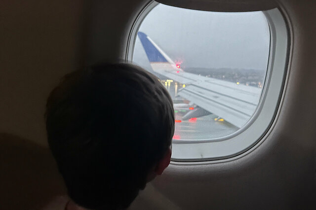 Julian looks out the window of an E175 landing at SFO