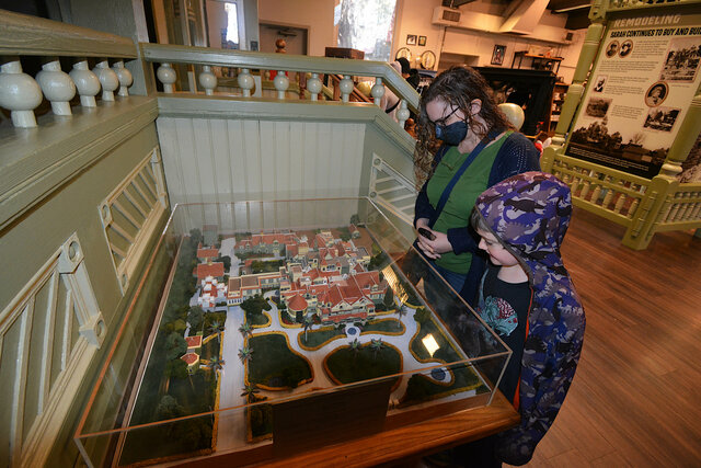 Kiesa and Julian look at a model of the Winchester Mystery House