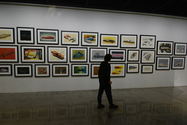 Calvin walking past a wall of art