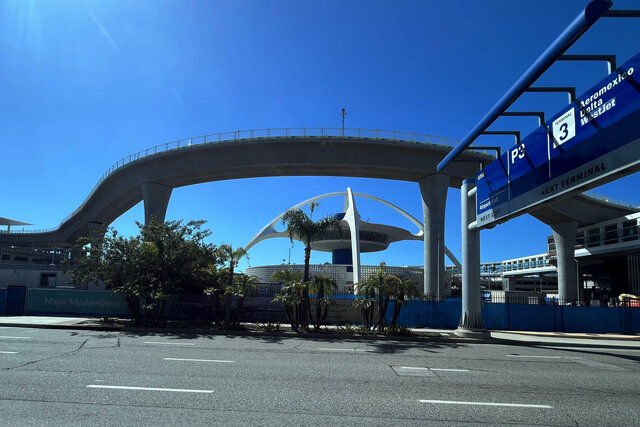 People-mover viaduct guides around the Theme Building