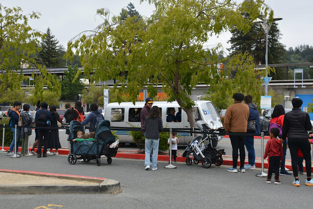 People queue at Orinda Station to ride BARTmobile