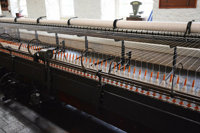 Spinning white yarn at New Lanark