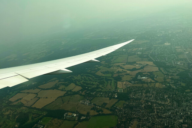 787 wing climbing out of Heathrow over the English countryside