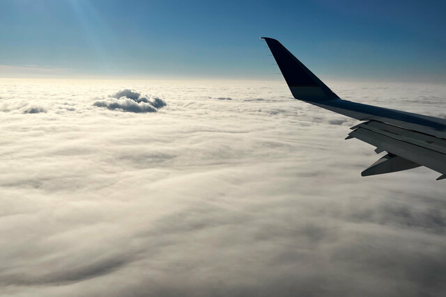 Plume rising through the clouds above Walter Scott Jr. power station