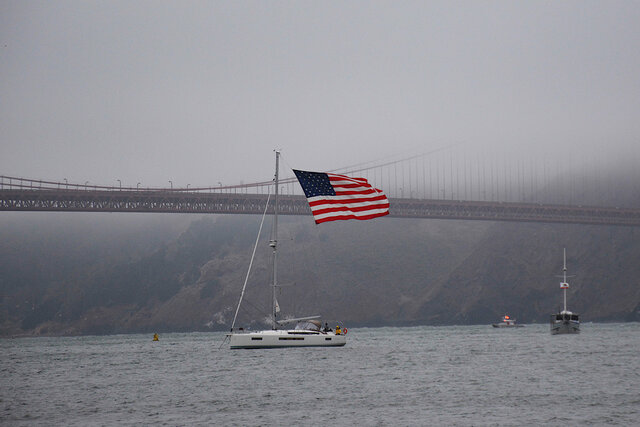Sailboat flying large American flag in the Golden Gate