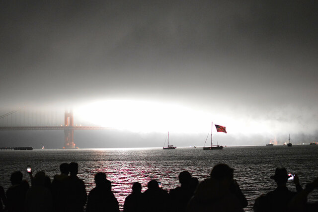 Fireworks light up the fog at the Golden Gate Bridge