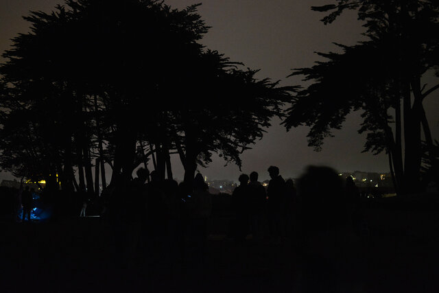 On the beach, backlit by the fog, after fireworks