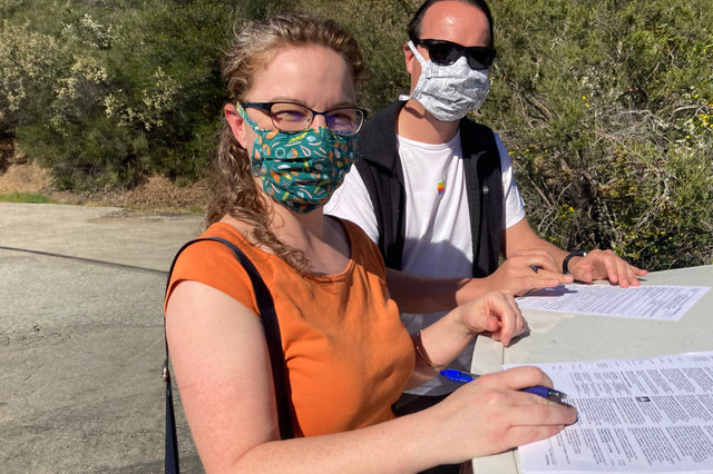 Kiesa and Jaeger signing mortgage papers on Loma Prieta Way