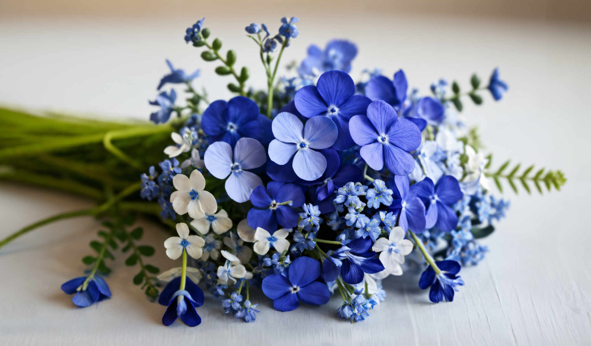 A beautiful arrangement of blue flowers and greenery.