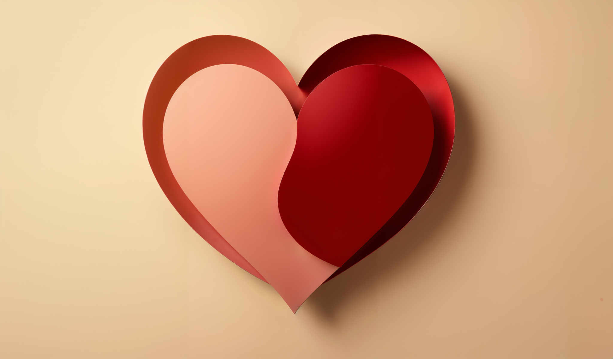 A heart shaped object is shown in a close up view. The heart is composed of two curved pieces of a vibrant red color. The two pieces are connected at the bottom forming a single heart shape. The background of the heart is a lighter shade of red providing a nice contrast to the darker red of the outer edges. The image is a closeup allowing for a detailed view of the object. The object appears to be made of a shiny material possibly plastic or metal. The overall image gives a sense of a heart-shaped decoration or ornament.