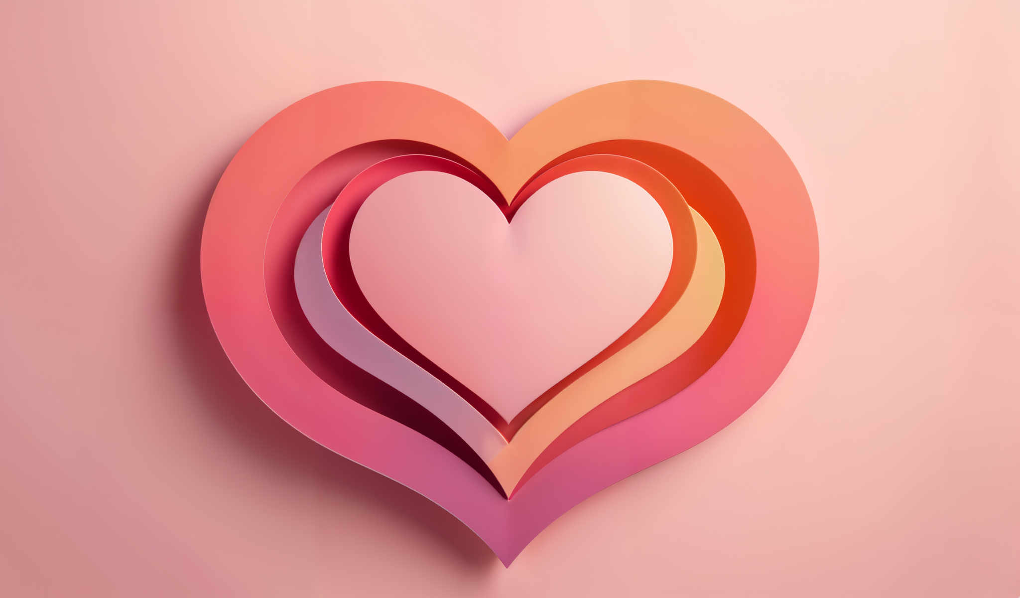 A heart-shaped cutout is composed of multiple layers of paper each a different color. The colors transition from pink to orange then to yellow and finally to green. The heart is set against a pink background.