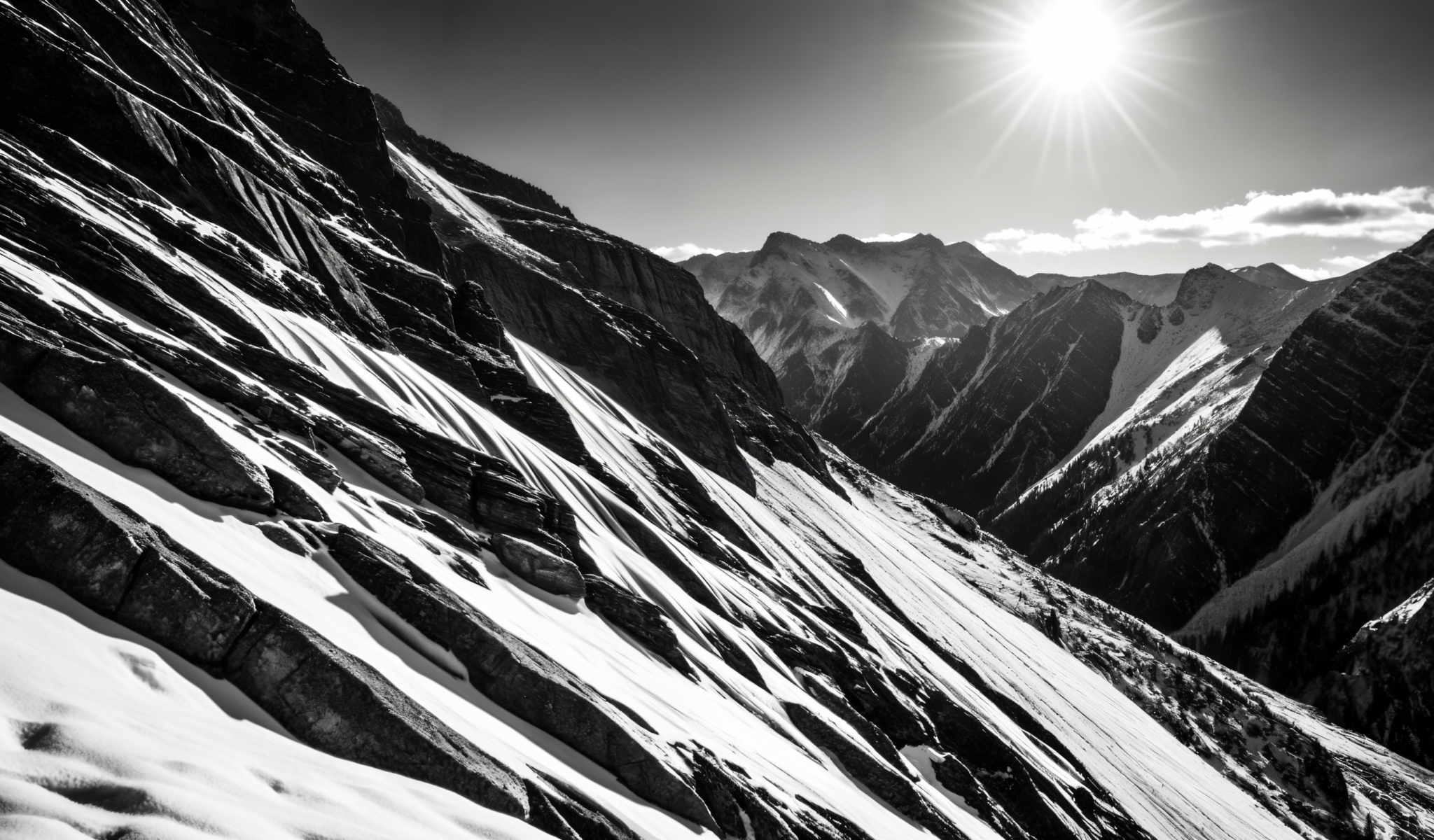 A breathtaking view of a mountain range with snow on the peaks. The mountains are jagged and rocky with a few patches of snow on them. The sky is clear and blue and the sun is shining brightly. The image is taken from a high vantage point looking down on the mountains. The colors in the image are predominantly blue white and gray. The sun is located in the top right corner of the photo. The photo is in black and white. The mountain range is in the background of the picture. The snow on top of the mountains is white. There are no people or animals in the photo and no text is visible. The relative positions of the objects in the picture are such that the mountains are in the distance and they are below the sun. The clear blue sky is above the mountains and the photo is taken at a high angle. The rocky terrain of the mountain range can be seen clearly. The overall scene is serene and beautiful.