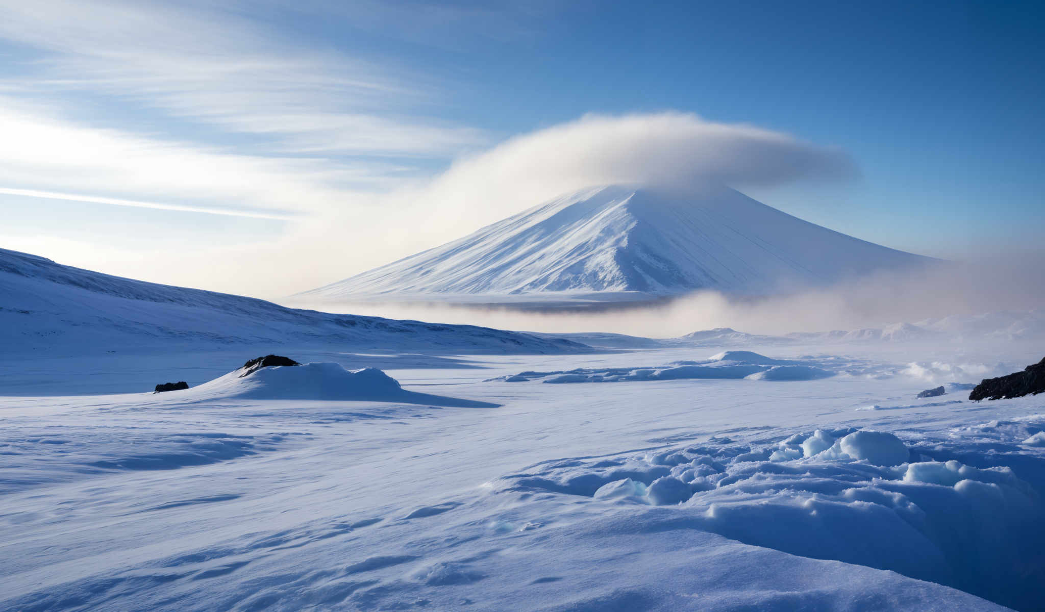 A snowy mountain with a large cloud on top.