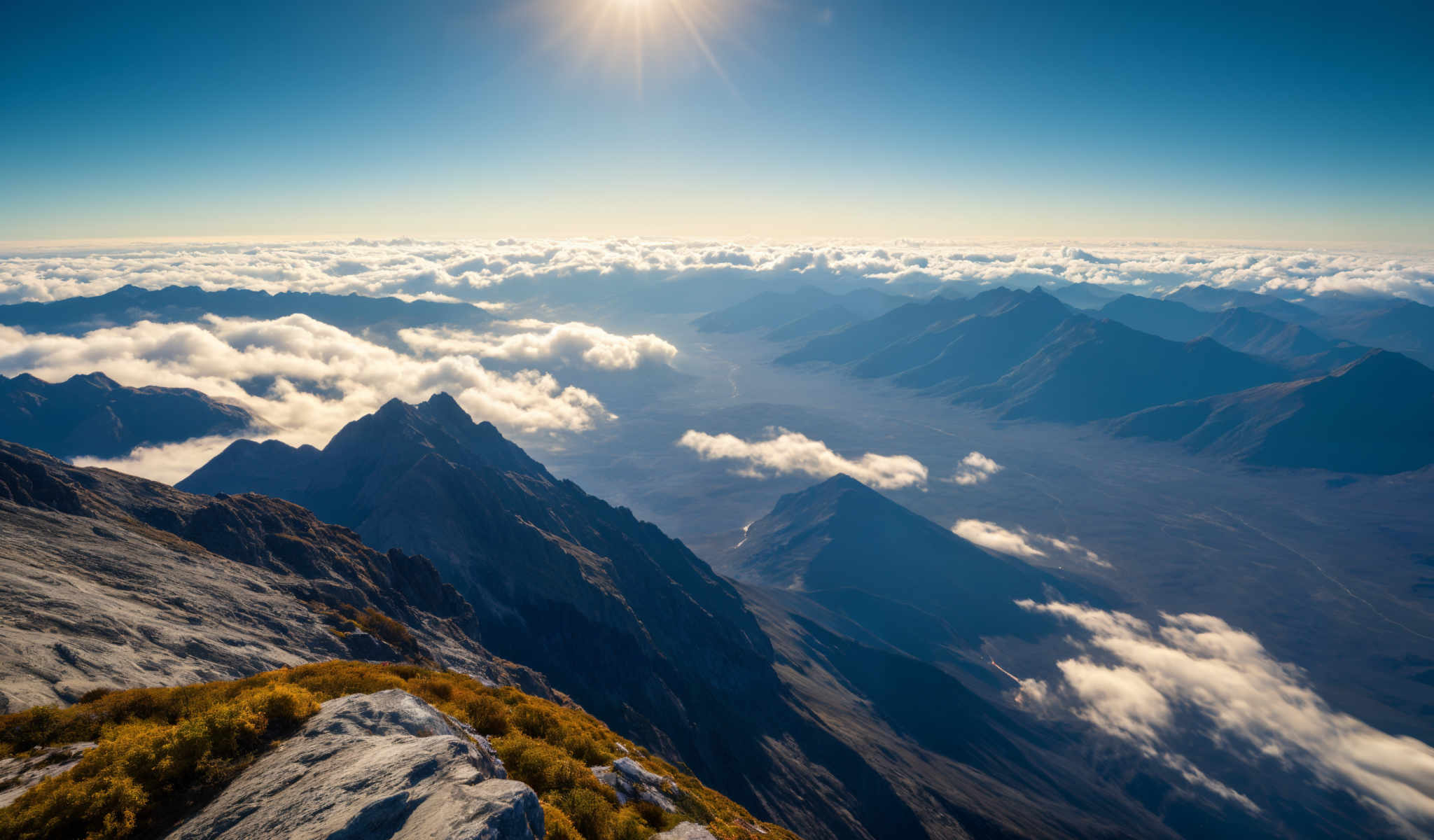 A breathtaking view of a mountain range with a clear blue sky above. The mountains are covered in a blanket of snow and clouds creating a serene and beautiful landscape. The sun is shining brightly in the sky casting a warm glow on the scene. The image captures the majesty and grandeur of nature with the mountains standing tall and proud. The sky is a clear brilliant blue adding to the overall beauty of the scene.

The mountains are densely covered in snow with patches of green grass peeking through here and there. The snow-covered peaks glisten in the sunlight creating stunning visual effects. The clouds are fluffy and white adding depth and texture to the sky. The overall scene is a testament to the beauty and power of nature.

The image is taken from a high vantage point looking down on the mountains. This perspective allows for a comprehensive view of the landscape from the towering peaks to the vast expanse of the sky above.

The colors in the image are vibrant and natural. The blue of the skies the white of the snow and the green of the grass create a beautiful contrast making the image visually stunning.

Overall the image is a stunning representation of nature's beauty capturing the majest