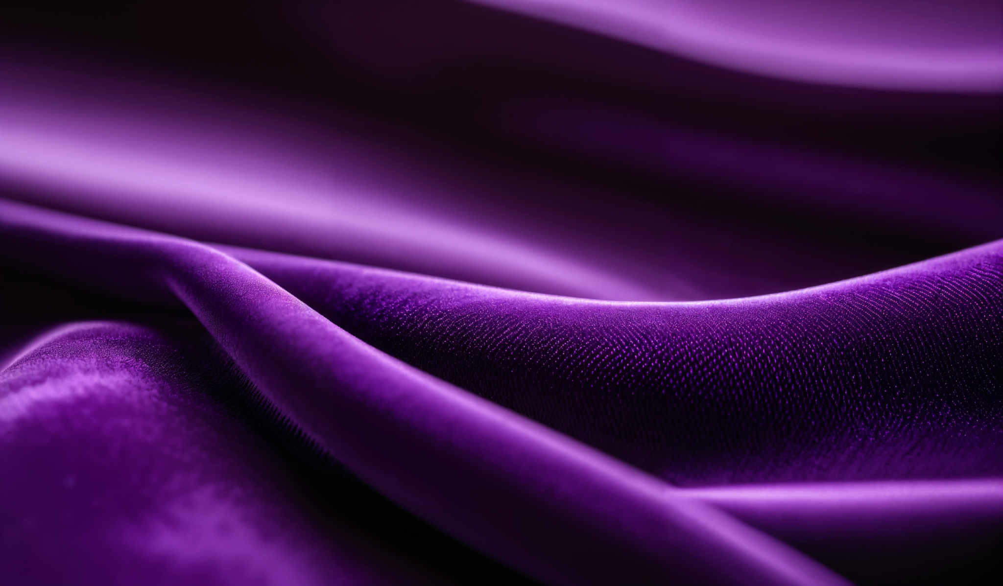 The image showcases a close-up view of a fabric, possibly silk or satin, with a deep purple hue. The fabric displays a smooth texture with subtle folds and creases, creating a wavy pattern. The lighting accentuates the richness of the color, highlighting the sheen and depth of the material.