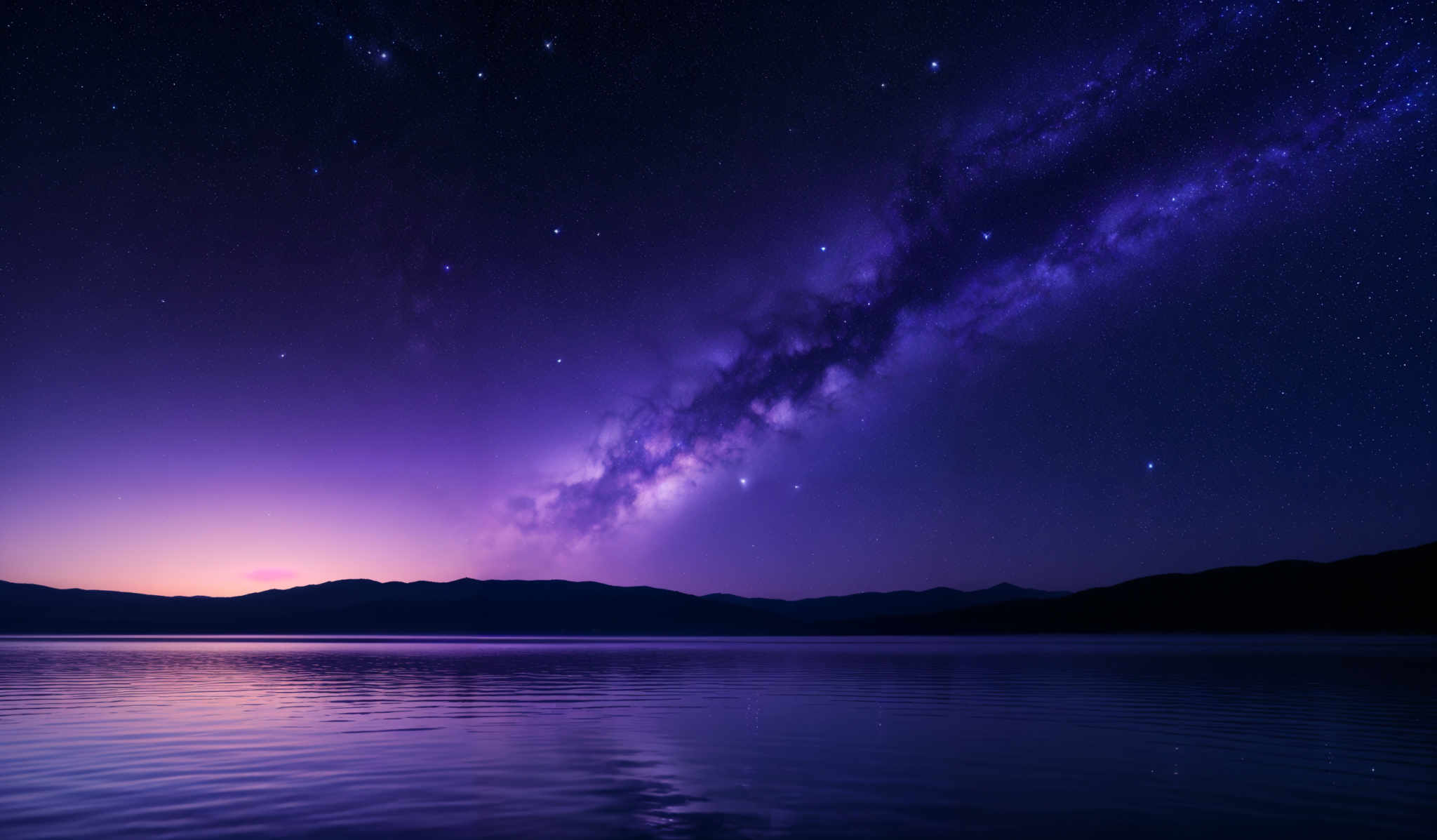 The image showcases a breathtaking view of the night sky. The dominant colors are deep purples, blues, and hints of pink. The Milky Way galaxy, with its dense cluster of stars, stretches across the sky, creating a milky, cloud-like appearance. The horizon displays a gradient of colors, transitioning from a deep purple at the top to a soft pink near the water. The water below reflects the colors of the sky and the silhouette of the mountains. The overall shape is a vast expanse of the universe, with the Earth's horizon acting as a boundary.