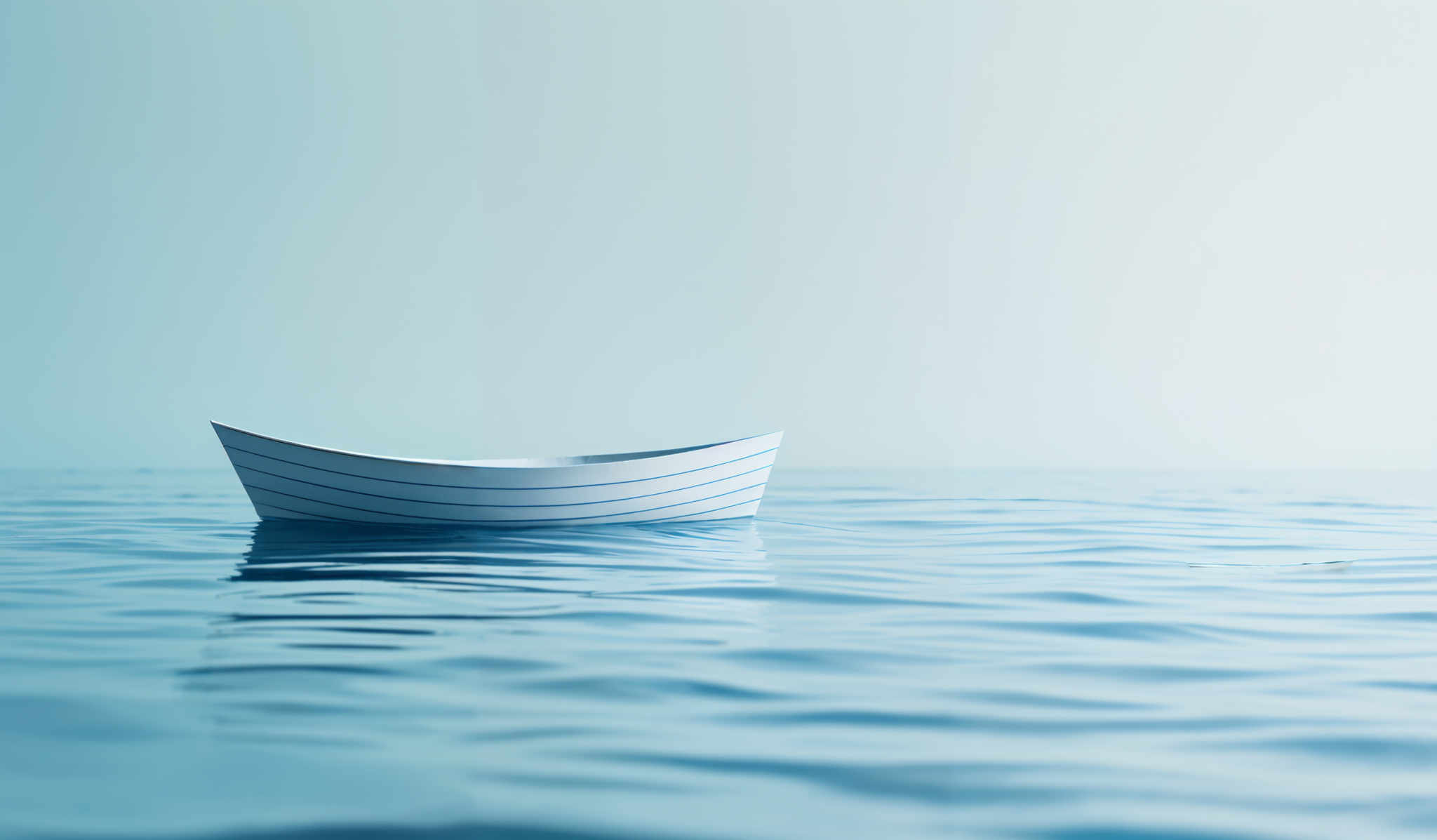 The image showcases a serene scene of a calm sea or ocean. Dominating the foreground is a solitary boat, which appears to be made of wood, with a striped design. The boat is floating on the water, and its reflection can be seen on the surface. The water itself is depicted in varying shades of blue, with gentle ripples. The background is a gradient of light blue, fading into a lighter hue, suggesting a vast expanse of water or perhaps the horizon.