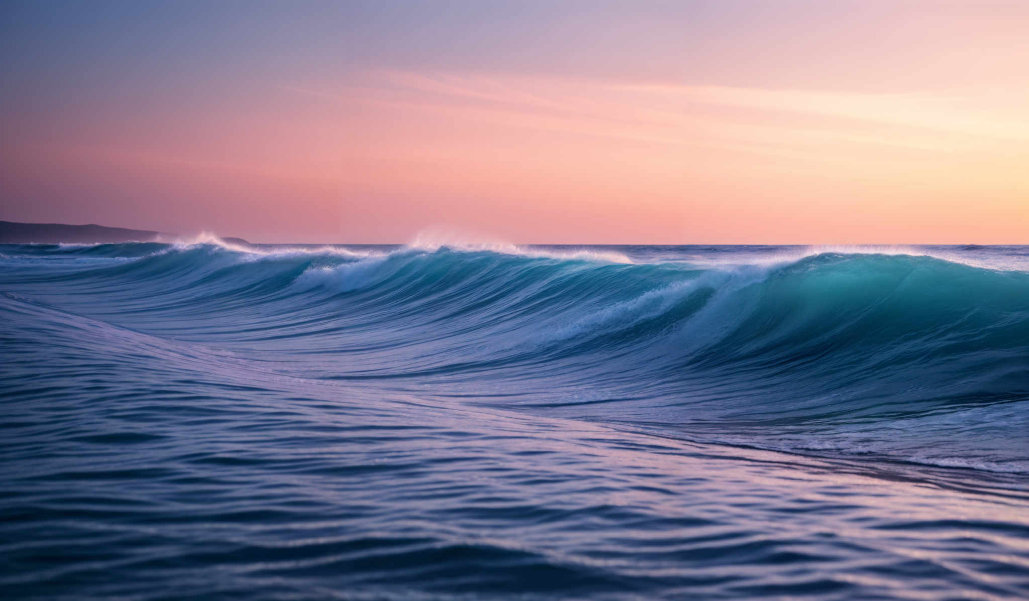 The image showcases a captivating seascape during what appears to be either dawn or dusk. Dominating the foreground is a large, powerful wave, with its translucent blue hue beautifully contrasted against the darker waters. The wave's crest is white, indicating the force and movement of the water. In the background, the horizon is painted with a gradient of colors, transitioning from a deep blue to a warm orange, signifying the sun's position just below the horizon. The sky is clear with a few wispy clouds, adding to the serene ambiance of the scene.