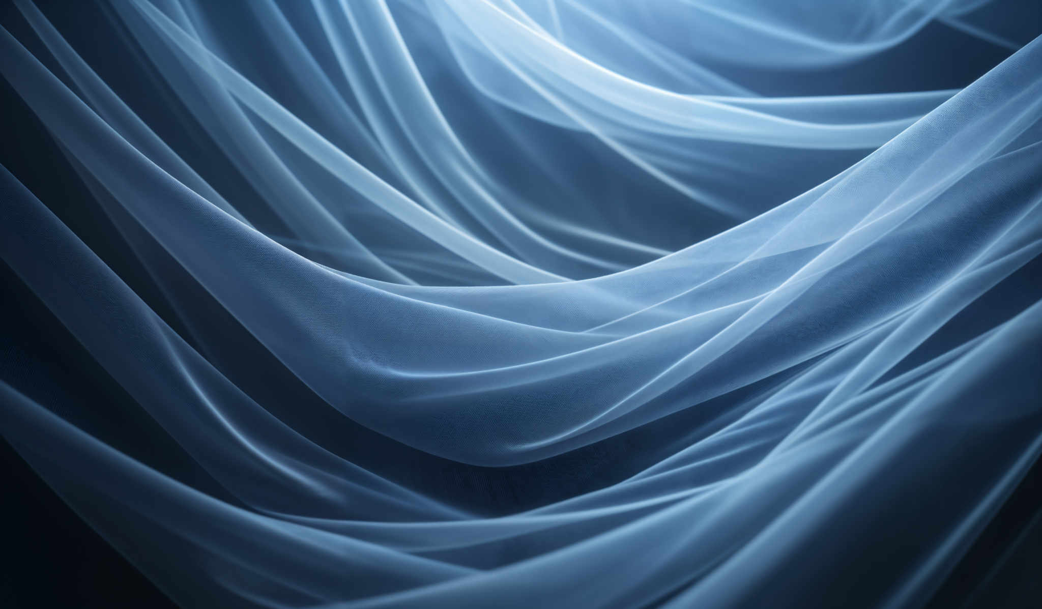 The image showcases a series of flowing, translucent, and delicate fabric or sheer material in varying shades of blue. The fabric appears to be draped in a cascading manner, creating a sense of movement and fluidity. The lighting accentuates the sheen and texture of the material, giving it a soft and ethereal quality.