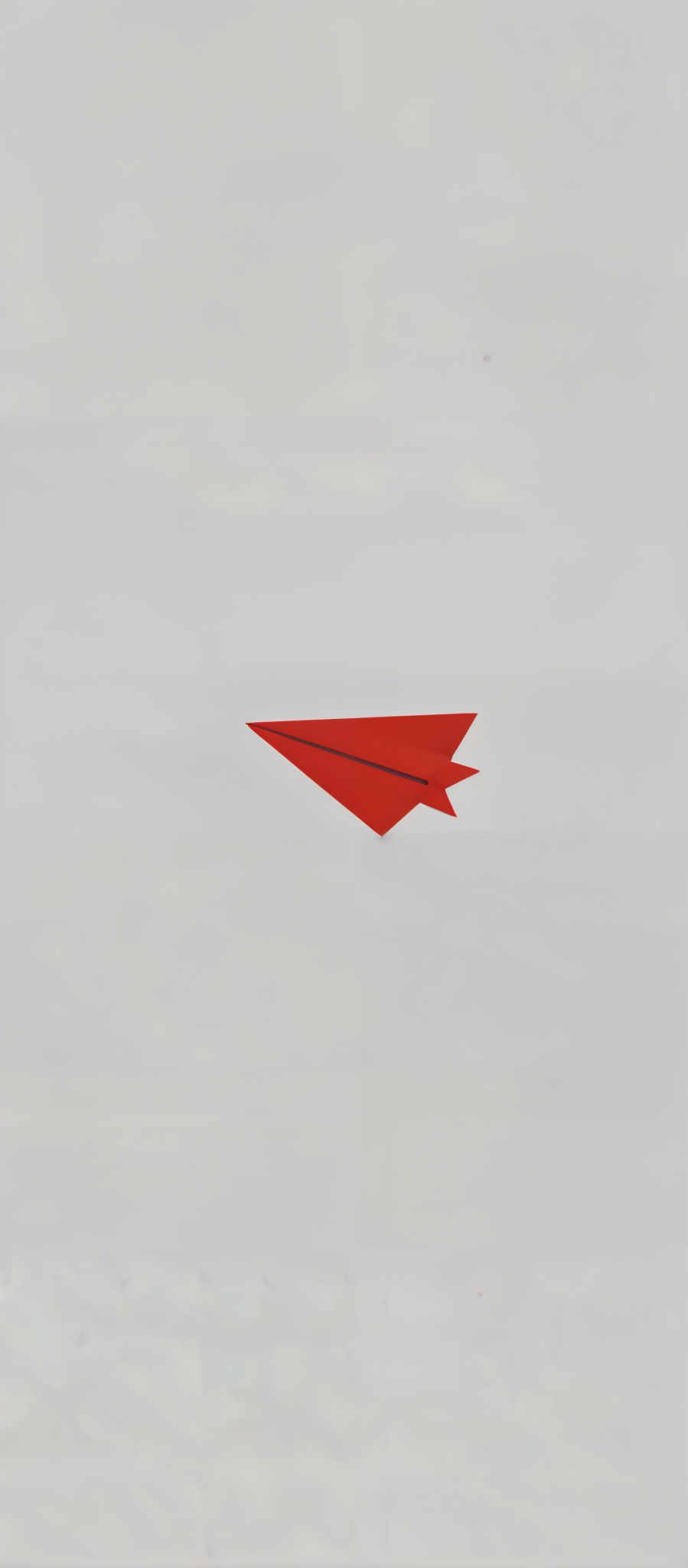 A vibrant red paper airplane is soaring through the sky its wings spread wide in a display of freedom and joy. The airplane crafted from a single piece of paper is the sole focus of the image its bright red color standing out against the stark white background. The art style is simple yet evocative with the paper airplane's flight suggesting movement and dynamism. The subject of the artwork is the airplane itself its form and color drawing the viewer's attention. The motif of flight and freedom is central to the composition evoking a sense of wonder and adventure.