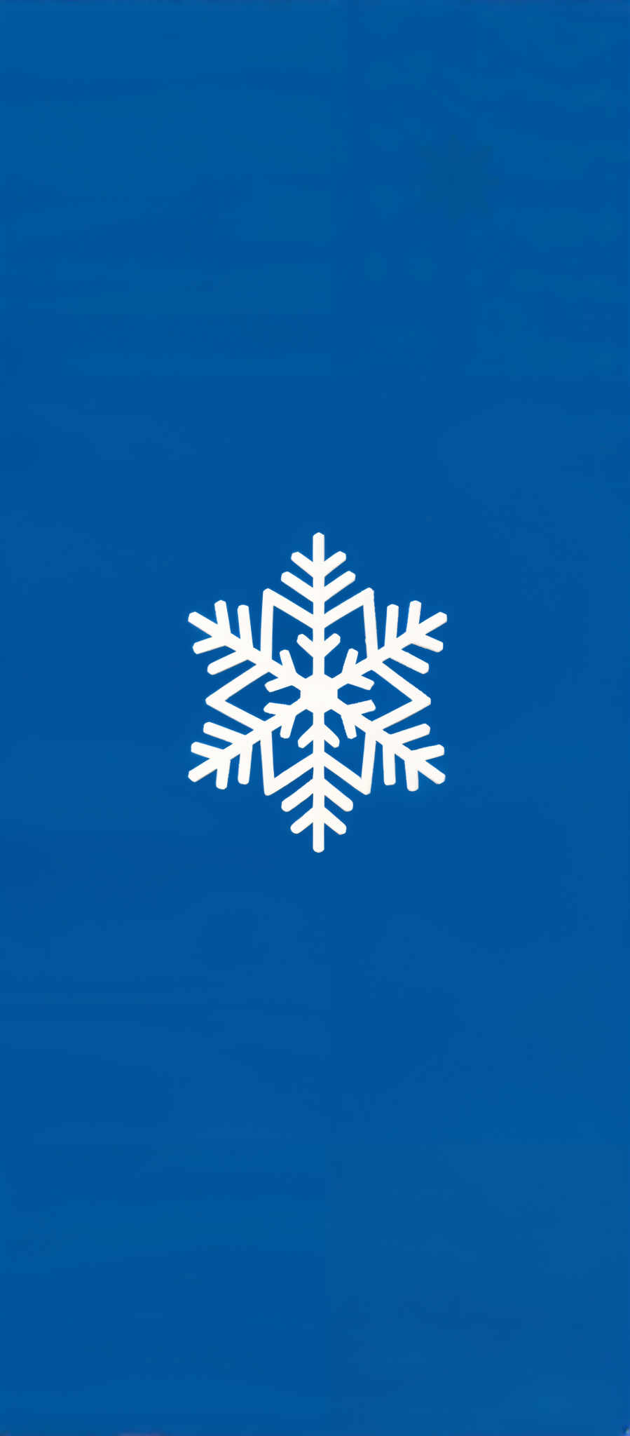 The image presents a striking contrast of a white snowflake against a blue background. The snowflake composed of six delicate petals is centrally positioned drawing the viewer's attention. The petals are intricately detailed showcasing the beauty of nature's artistry. The blue background provides a calming backdrop enhancing the overall visual appeal. The image is captured in a square format adding to its symmetry and balance. The simplicity of the design and the use of contrasting colors make this image visually captivating.