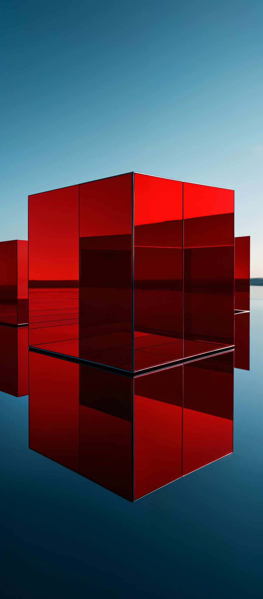 The image showcases a series of three rectangular cubes made of a reflective material, possibly glass or metal. They are positioned on a calm body of water, creating a mirrored reflection on the surface. The cubes are colored in varying shades of red, with the central cube being the brightest and the ones on the sides being slightly darker. The background consists of a clear blue sky with a hint of clouds.