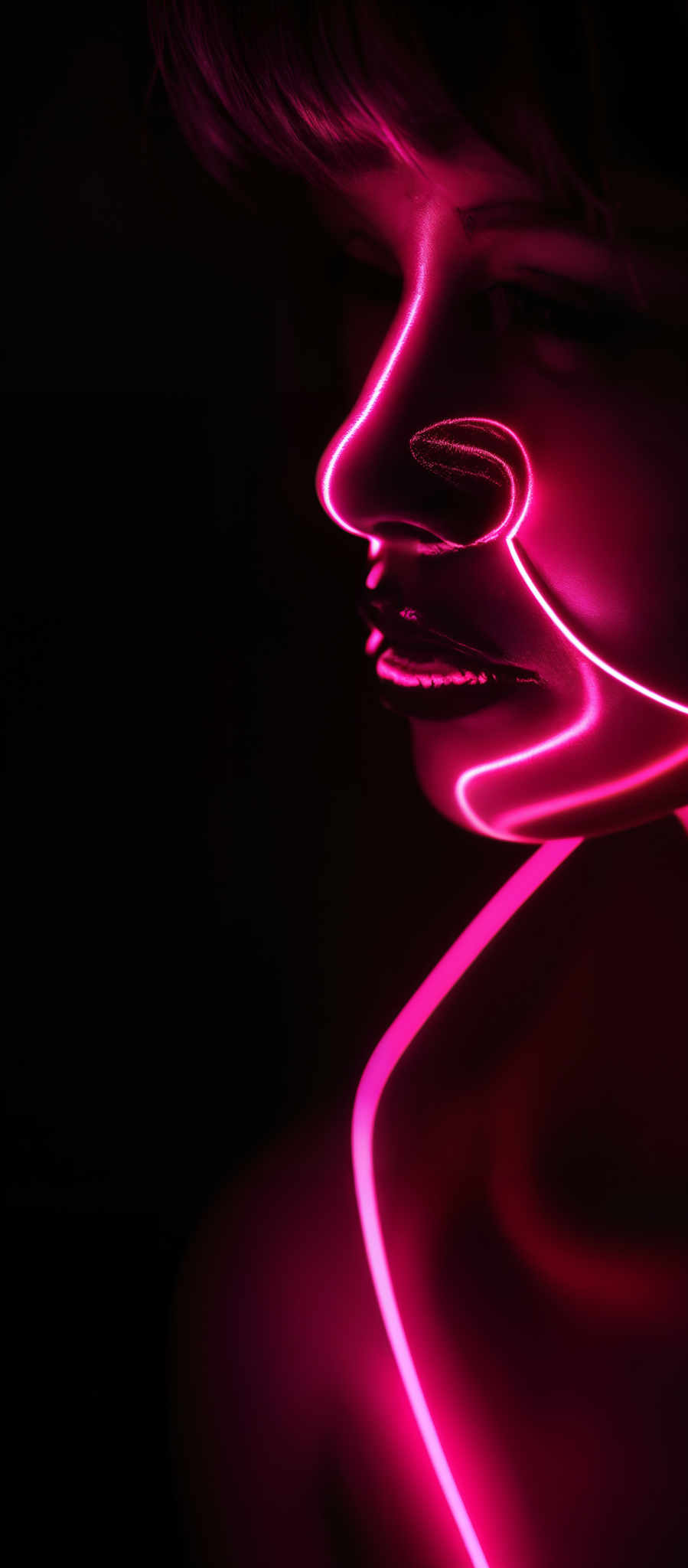 The image predominantly features a deep red hue, creating a moody and intense atmosphere. The shape is intricate, with a neon-like light tracing a curvy path around the face, particularly emphasizing the nose and lips. The light creates a play of shadows and highlights, adding depth and dimension to the image, while the dark background accentuates the luminosity of the neon light.