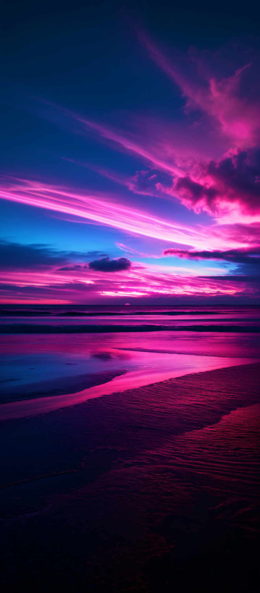 The image showcases a breathtaking sunset over a beach. The sky is painted with a myriad of colors, ranging from deep blues to fiery oranges and pinks. Wispy clouds are scattered across the sky, reflecting the vibrant hues of the setting sun. The horizon shows a gentle blend of these colors, transitioning into a deeper blue as it extends outward. Below, the calm waters of the beach reflect the colors of the sky. The beach itself has a dark silhouette, with subtle patterns suggesting the ebb and flow of the tide.