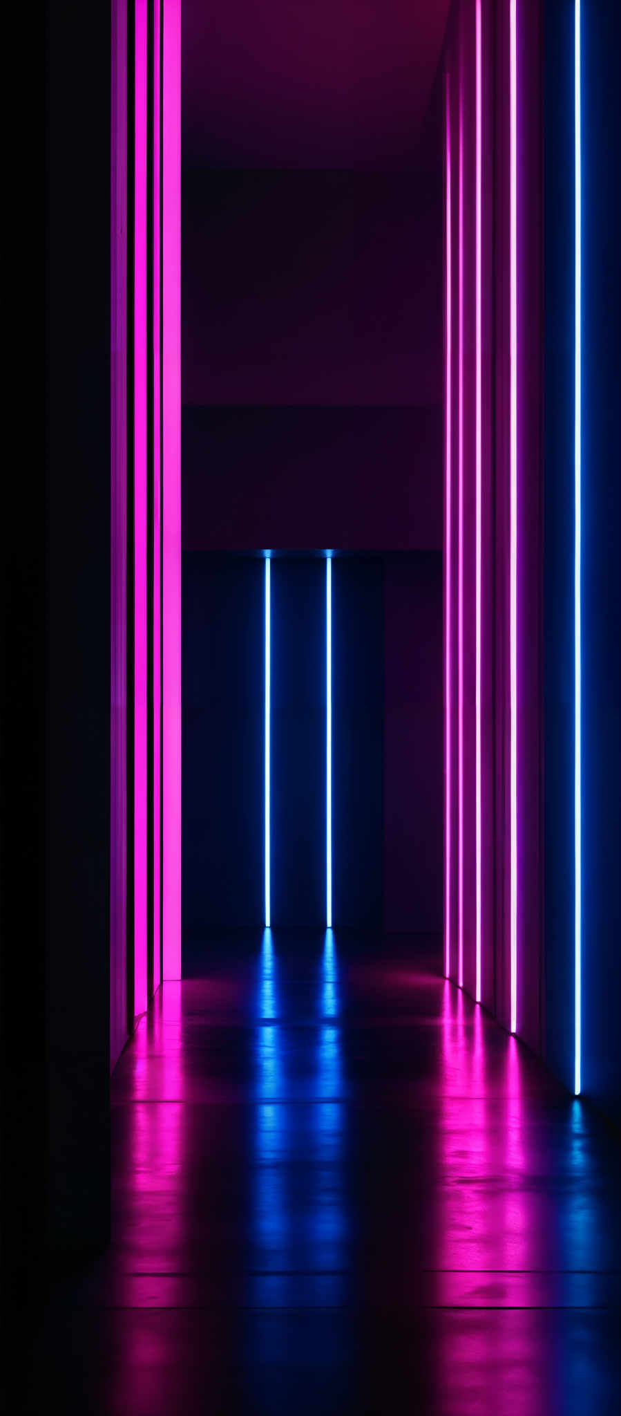 The image showcases a room with a dark ambiance. There are vertical light strips emitting vibrant colors: pink on the left and blue on the right. These strips are evenly spaced and illuminate the room, creating reflections on the floor. The floor itself appears to be made of a smooth, reflective material, possibly polished concrete or a similar substance. The walls are dark, possibly black or deep gray, which contrasts with the bright colors of the light stripes.