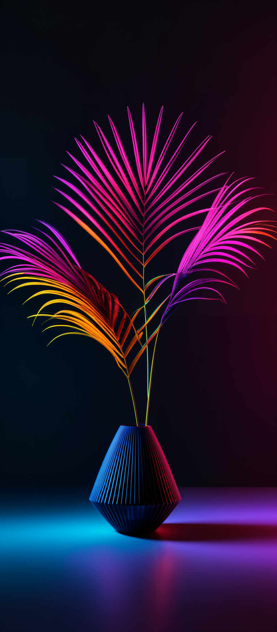 The image showcases vibrant neon colors illuminating a palm-like plant with long, slender leaves. The leaves are bathed in hues of pink, purple, and orange, creating a surreal and vivid visual effect. The plant is placed in a dark-colored, geometrically shaped vase. The background is pitch-black, which accentuates the bright colors of the plant and the reflective surface below.