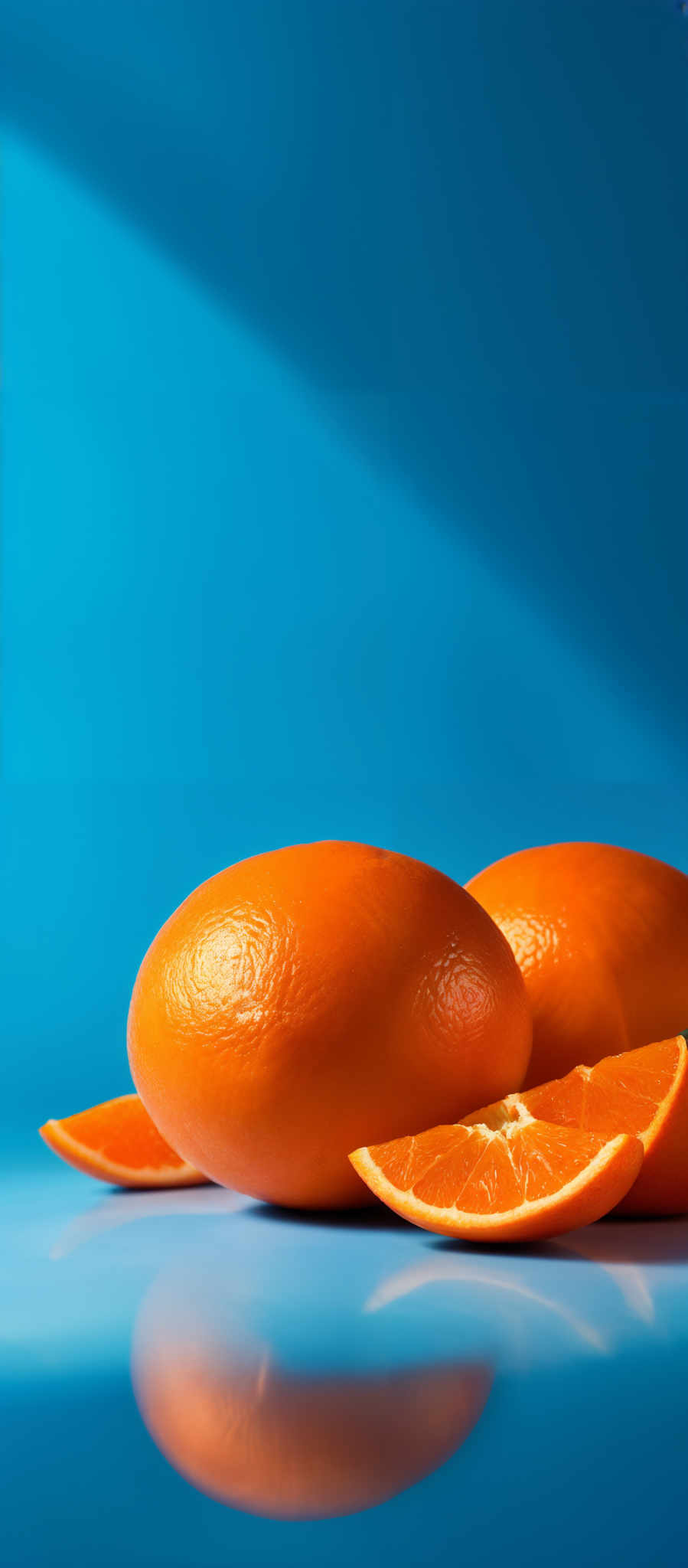 The image showcases a vibrant blue background with a diagonal light streak. In the foreground, there are three oranges. Two of them are whole, while one is sliced, revealing its juicy, orange interior. The oranges have a smooth, glossy surface, reflecting the light from the background. The slice of the orange is placed on a reflective surface, creating a mirrored image of the slice.