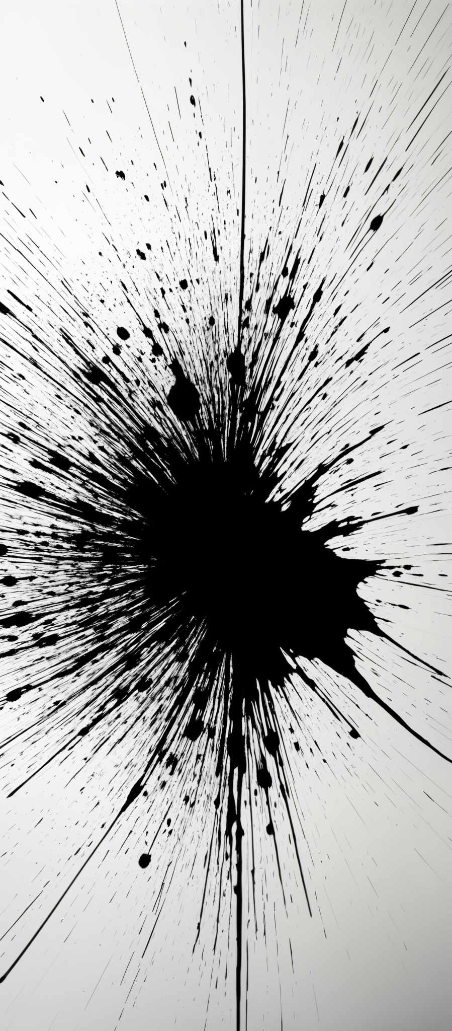 The image predominantly features a stark contrast between black and white. It showcases a radial explosion of black ink or paint splatters emanating from a central point. The splatTERs radiate outward in all directions, creating a dynamic and chaotic effect. The central point is darker than the surrounding area, drawing the viewer's attention immediately. The overall shape resembles a burst or explosion, reminiscent of a firework or an artistic representation of energy.