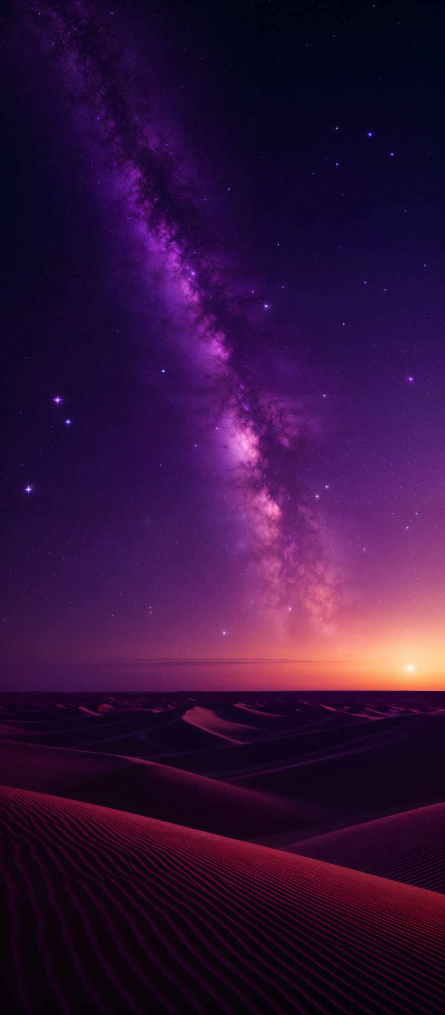 The image showcases a breathtaking view of a desert landscape at night. The foreground features undulating sand dunes with intricate patterns, possibly created by wind erosion. The dunes are bathed in a warm, reddish-orange hue, possibly from the setting or rising sun. Above the dunes, the night sky is a tapestry of deep purples and blues, dotted with numerous stars. The Milky Way galaxy stretches across the sky, its dense, cloudy band of stars and interstellar dust creating a mesmerizing contrast against the dark backdrop.