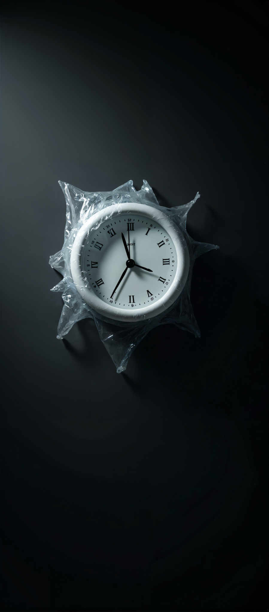 A white clock with black numbers and hands is encased in a clear plastic bag.