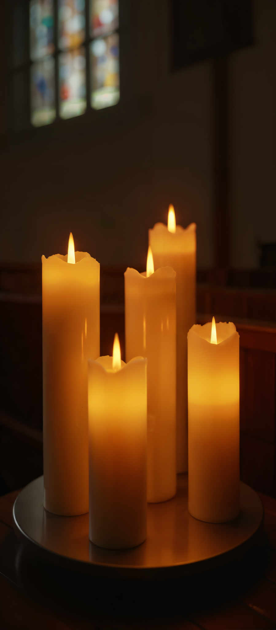 A group of candles with a warm glow.