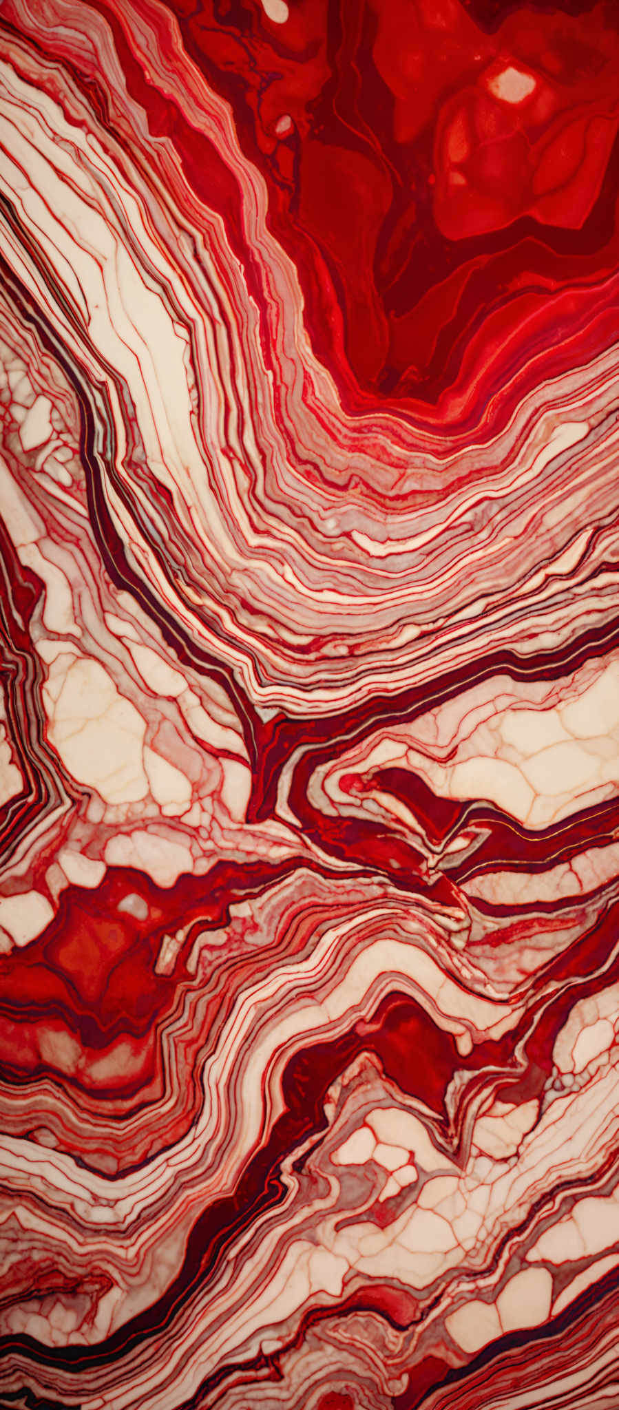 The image showcases a vibrant and intricate marble-like pattern. It features swirling layers of red, white, and shades of brown. The patterns resemble the flow of lava or the layers of sedimentary rock, with the red and white creating a contrasting yet harmonious visual effect.