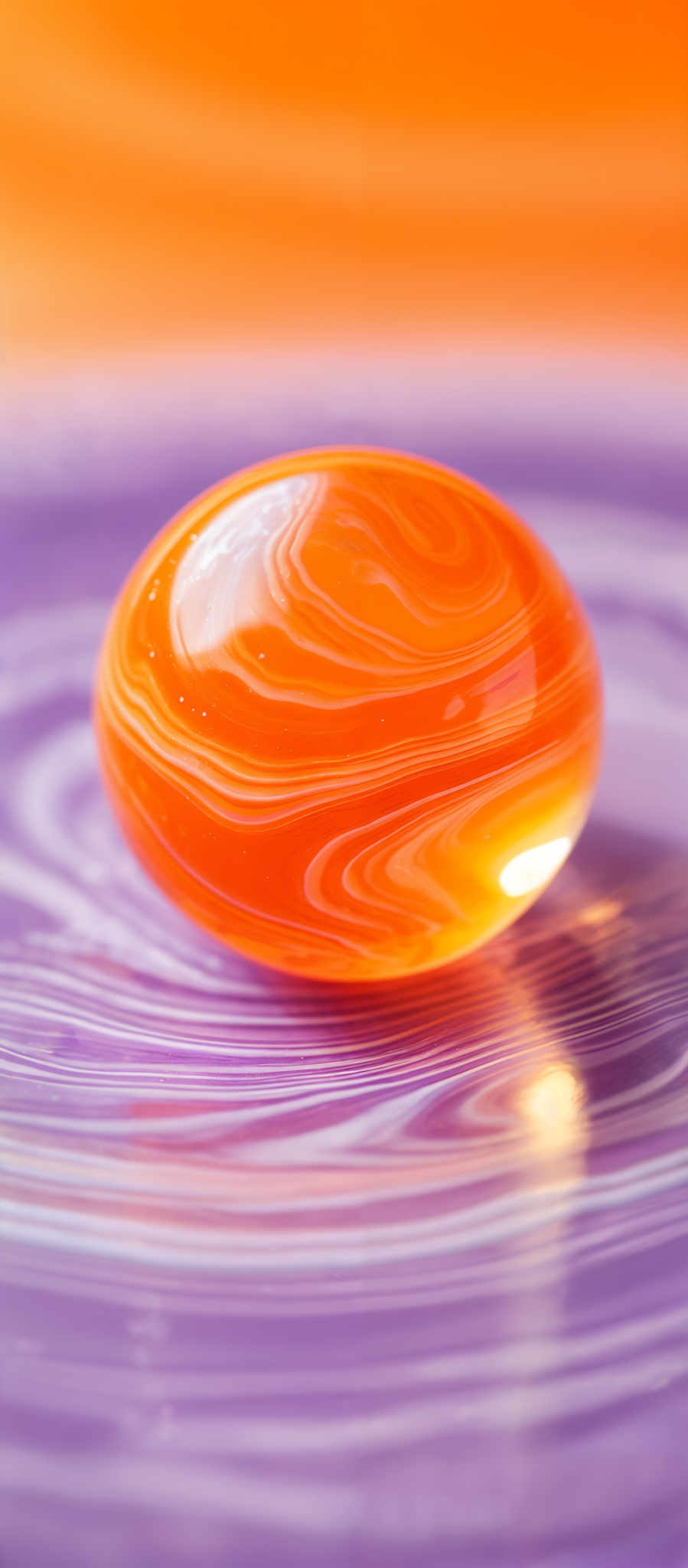 The image showcases a vibrant, oval-shaped object with swirling patterns of orange and white. The object appears to be placed on a surface with a similar swirled pattern, creating a harmonious visual effect. The background is dominated by a gradient of orange hues, transitioning from a deeper shade at the top to a lighter one at the bottom.