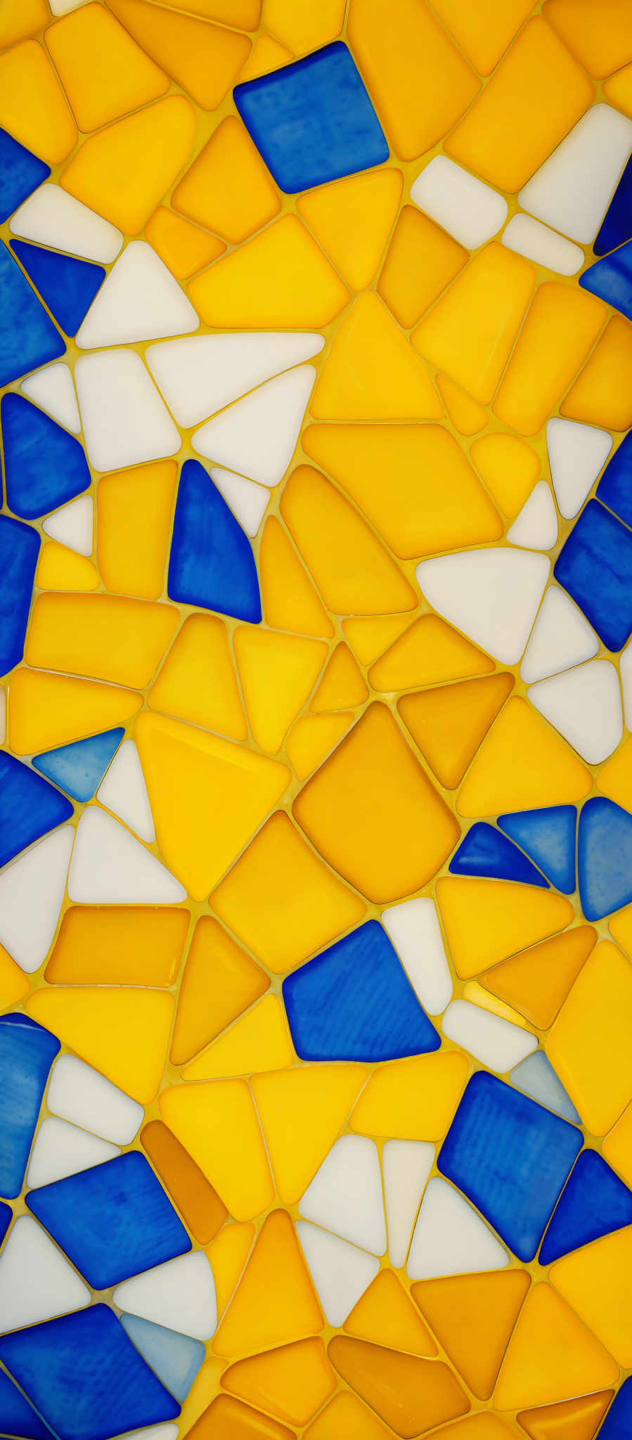 The image showcases a mosaic pattern made up of various geometric shapes. The dominant colors are shades of yellow, blue, and white. The shapes are predominantly triangles, with some rectangles interspersed. The mosaics are connected by thin lines, creating a network of interlocking pieces. The overall design gives a sense of depth and three-dimensionality, reminiscent of a broken glass or ceramic tile pattern.