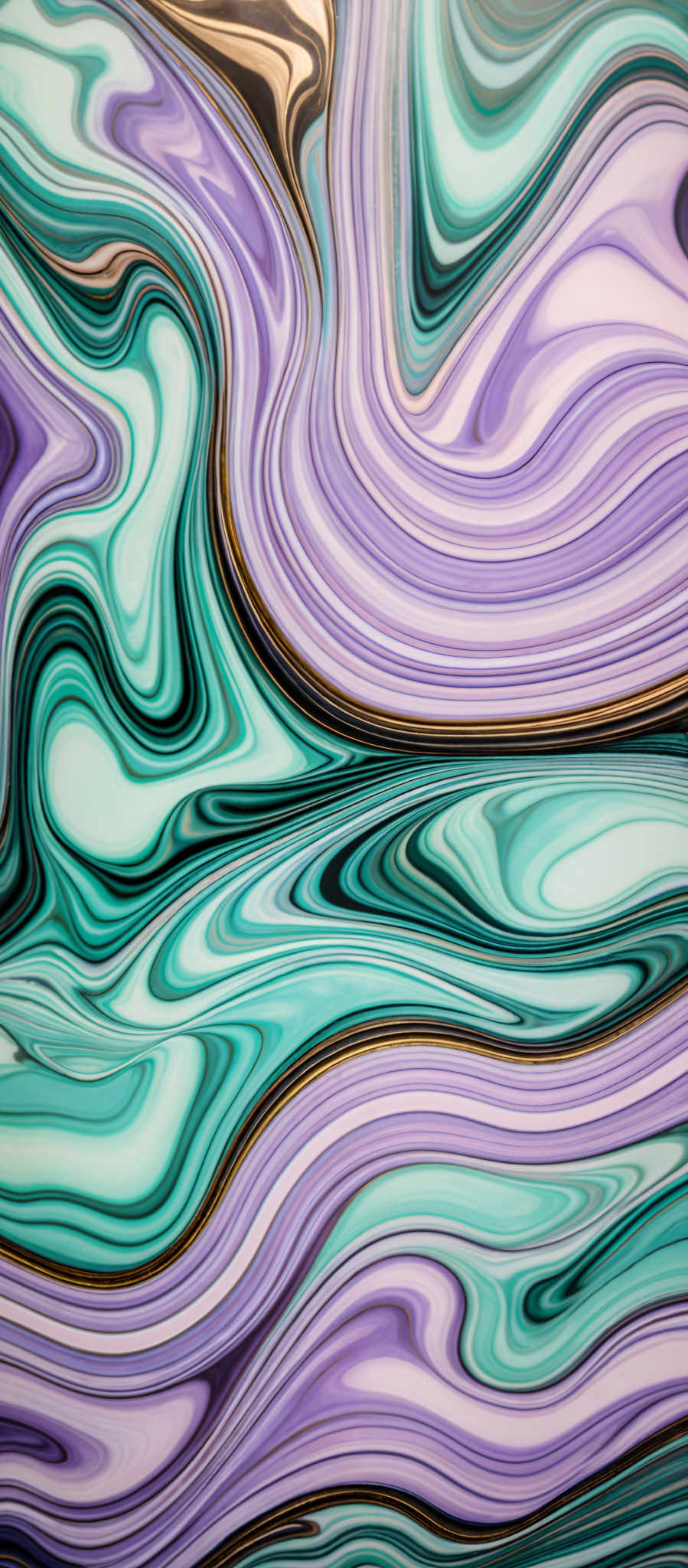 The image showcases a vibrant and intricate pattern of swirling colors. The dominant colors are shades of blue, purple, and teal, with hints of gold. The swirls are fluid and wavy, creating a marbled or agate-like appearance. The patterns seem to flow and intertwine, creating an almost organic and mesmerizing visual effect.