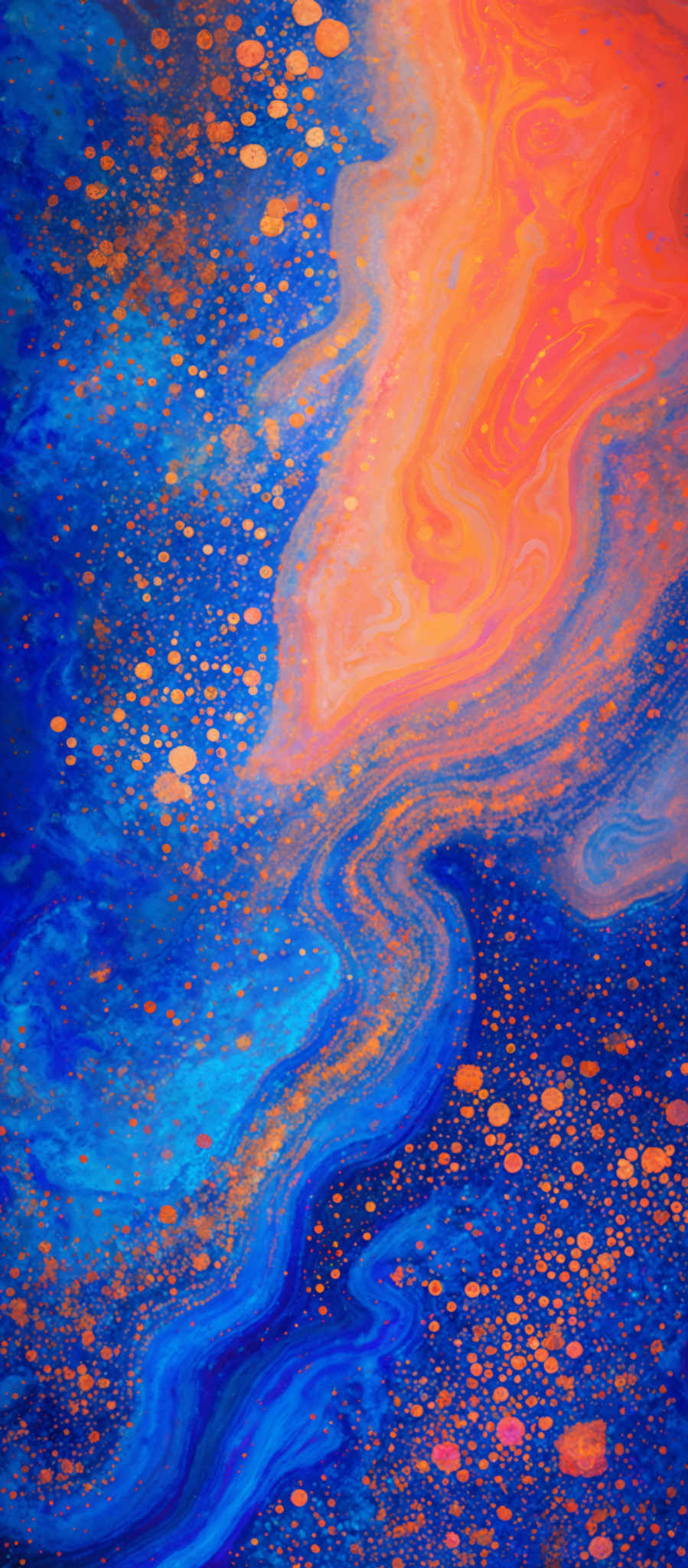 The image showcases a vibrant and mesmerizing blend of colors. Dominantly, there are shades of blue, ranging from deep navy to lighter aqua, interspersed with swirling patterns of orange and gold. The orange and golden hues seem to resemble a fluid or liquid, possibly representing a sunset or a celestial body, while the blue tones evoke the feeling of a vast ocean or a cosmic expanse. The image also contains numerous small, circular patterns scattered throughout, which could be interpreted as bubbles or distant stars.